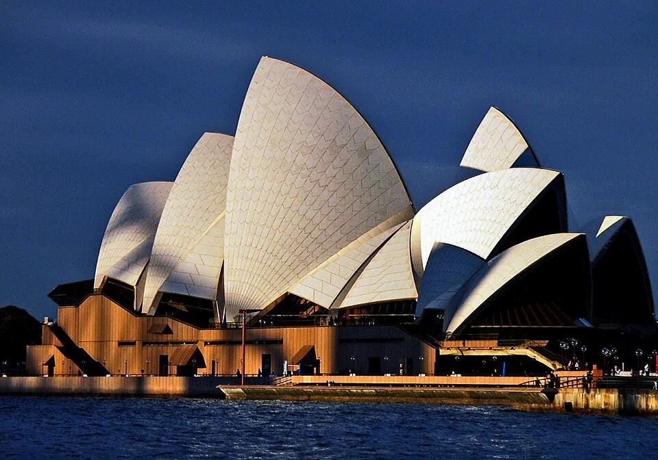 The white sails of the Sydney Opera House against a dark blue sky